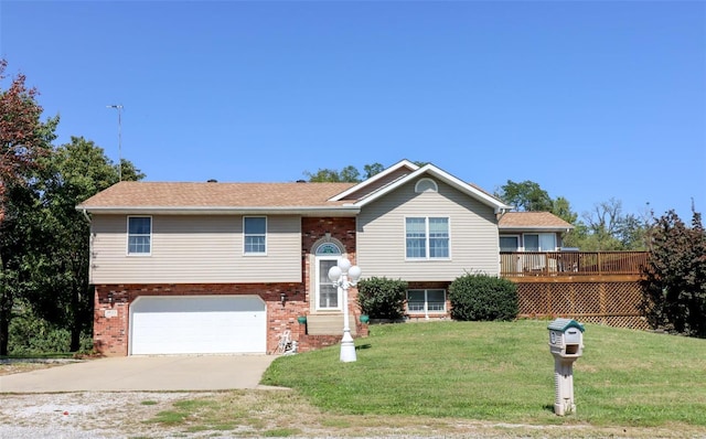 split foyer home featuring a garage, a deck, and a front lawn