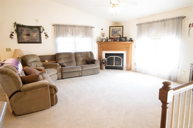 carpeted living room featuring vaulted ceiling and ceiling fan