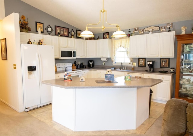 kitchen featuring white appliances, decorative light fixtures, white cabinetry, a center island, and vaulted ceiling