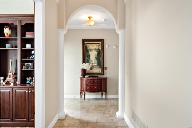 corridor with ornate columns and crown molding