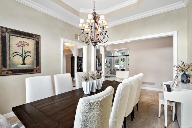 dining space featuring a chandelier and ornamental molding