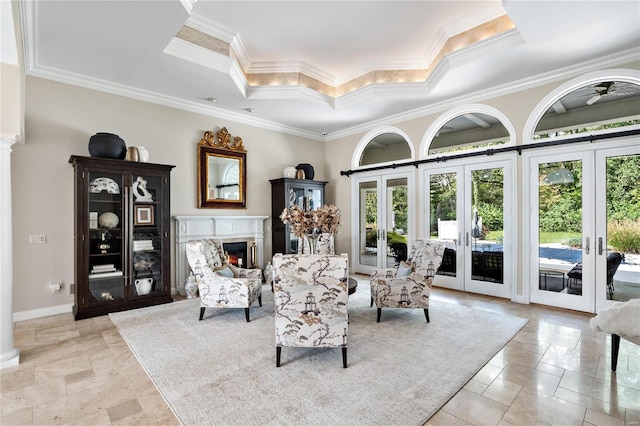 living room featuring french doors, a raised ceiling, crown molding, and a high end fireplace