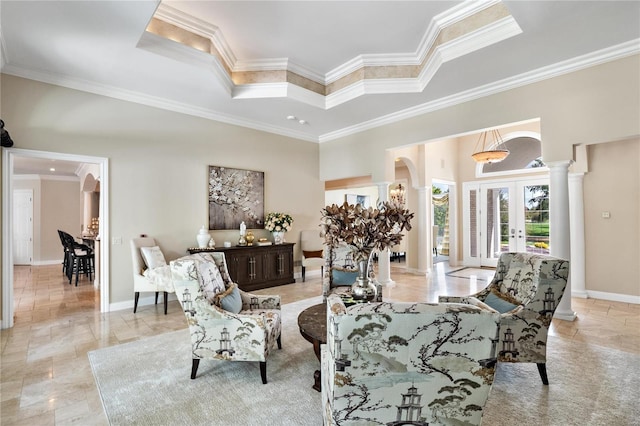 living room featuring ornate columns, french doors, crown molding, and a high ceiling