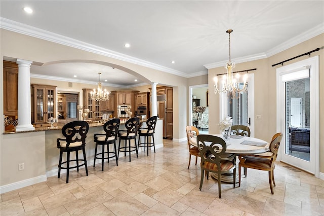 dining room featuring crown molding, decorative columns, and plenty of natural light