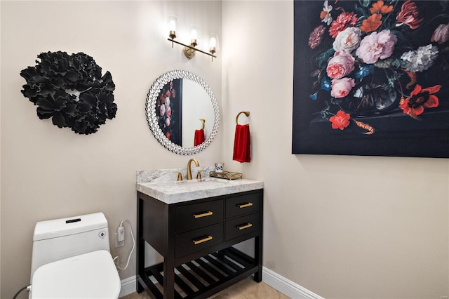 bathroom featuring vanity and toilet