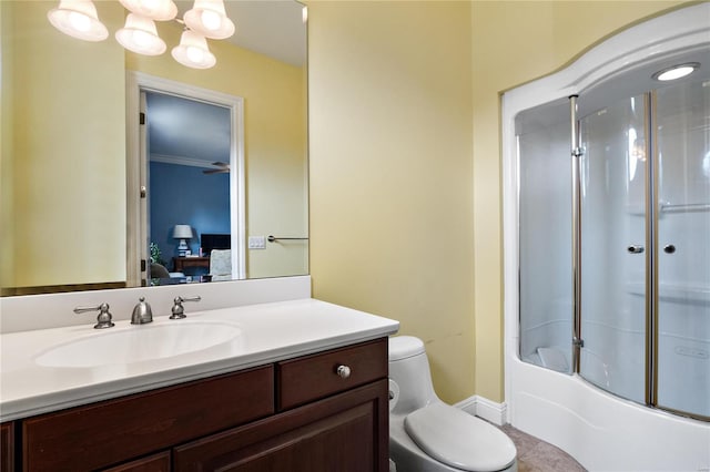 full bathroom with vanity, a notable chandelier, crown molding, combined bath / shower with glass door, and toilet