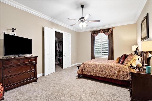 carpeted bedroom featuring a closet, crown molding, and ceiling fan