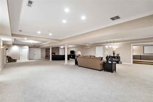 carpeted living room with ornamental molding, a fireplace, and a raised ceiling