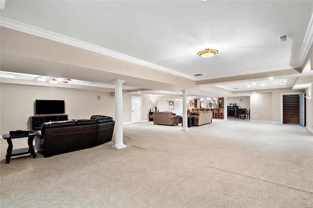 carpeted living room with ceiling fan, a tray ceiling, crown molding, and ornate columns