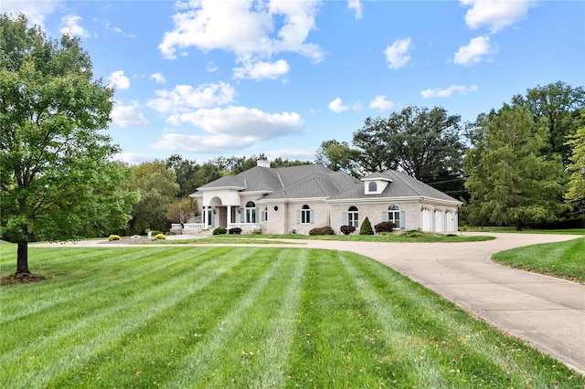 view of front of home with a porch and a front yard