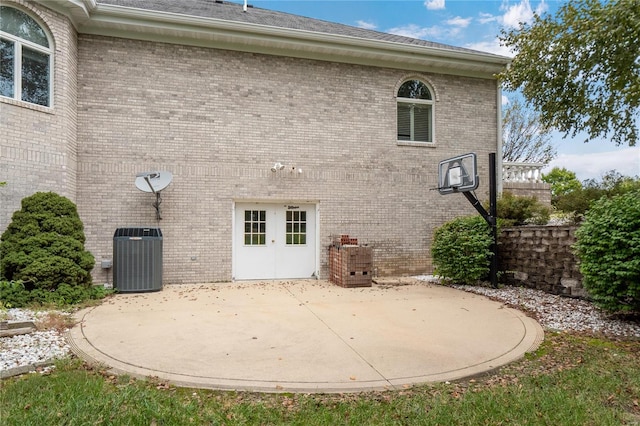 rear view of house featuring central AC unit and a patio area