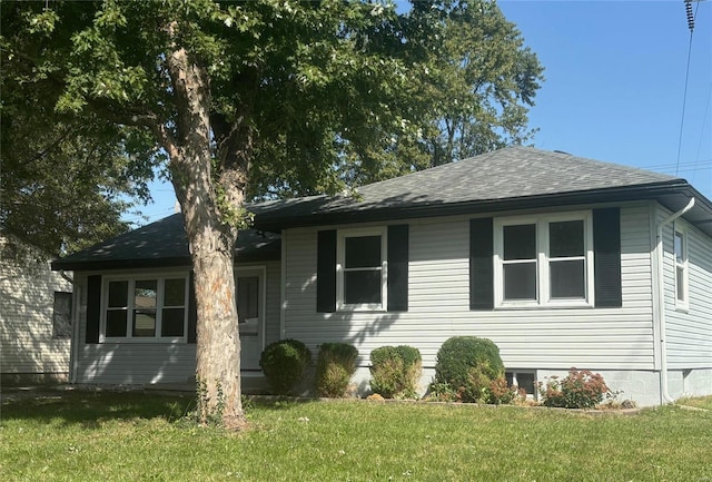 view of side of property with a yard