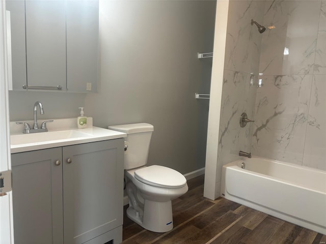 full bathroom with toilet, wood-type flooring, vanity, and tiled shower / bath combo