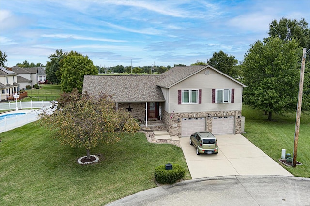 view of front of property with a front yard and a garage