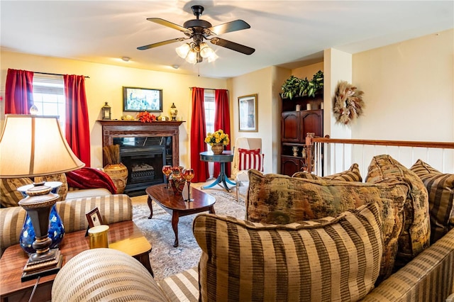 living room featuring ceiling fan and a premium fireplace