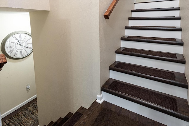 staircase with hardwood / wood-style flooring