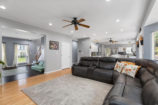 living room with ceiling fan, hardwood / wood-style flooring, and a wealth of natural light