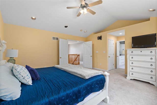 carpeted bedroom with ceiling fan and vaulted ceiling