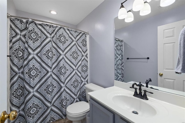 bathroom featuring vanity, toilet, and curtained shower