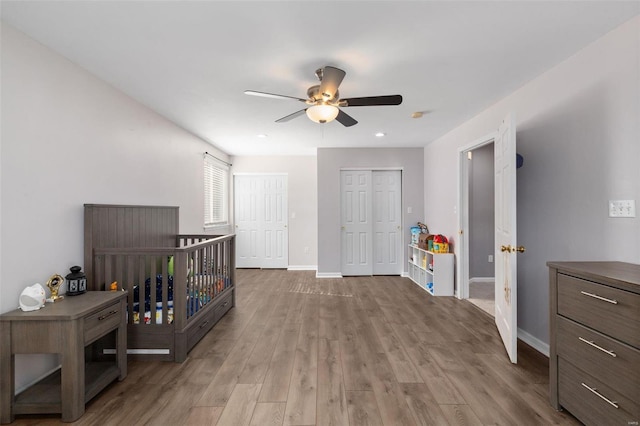 bedroom featuring light hardwood / wood-style flooring and ceiling fan