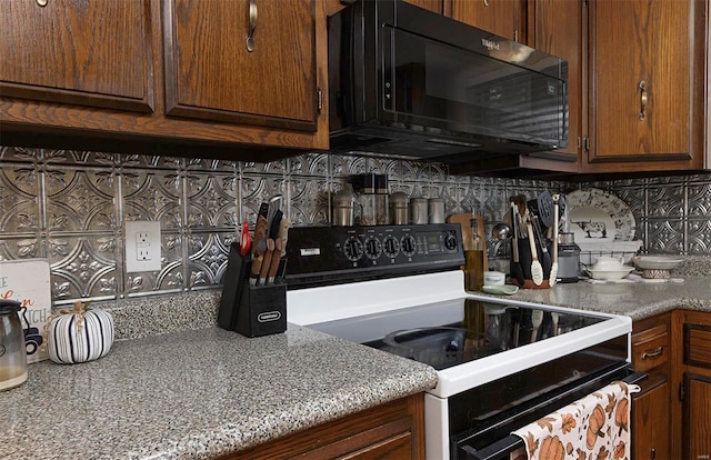 kitchen with black appliances and tasteful backsplash