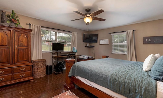 bedroom with ceiling fan and dark hardwood / wood-style flooring