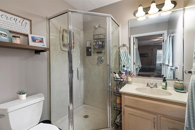 bathroom featuring walk in shower, vanity, and toilet