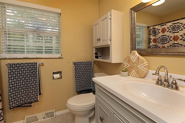 bathroom with vanity, tile patterned flooring, and toilet