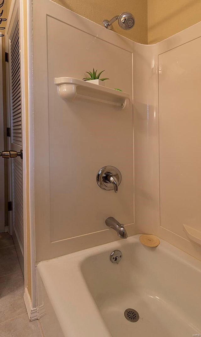 bathroom featuring plus walk in shower and tile patterned floors