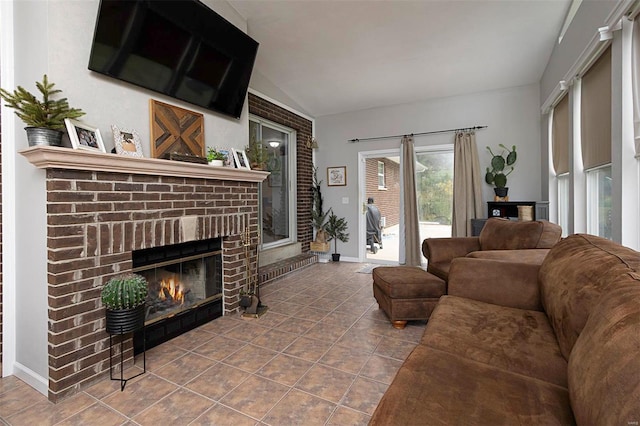 living room with a brick fireplace, tile patterned flooring, and vaulted ceiling