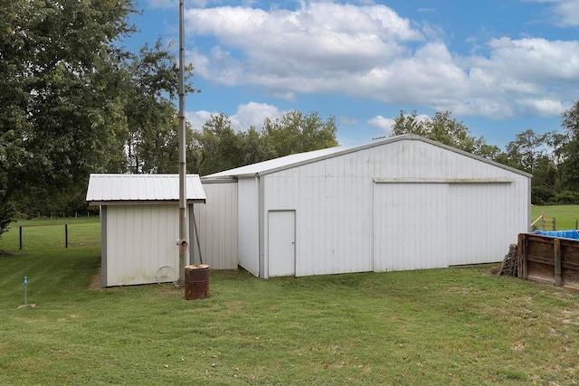 view of outbuilding featuring a lawn