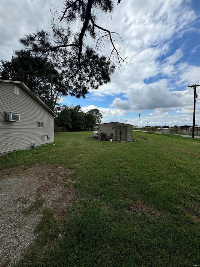 view of yard with a shed and a wall mounted AC