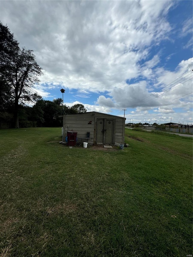 view of outdoor structure featuring a lawn