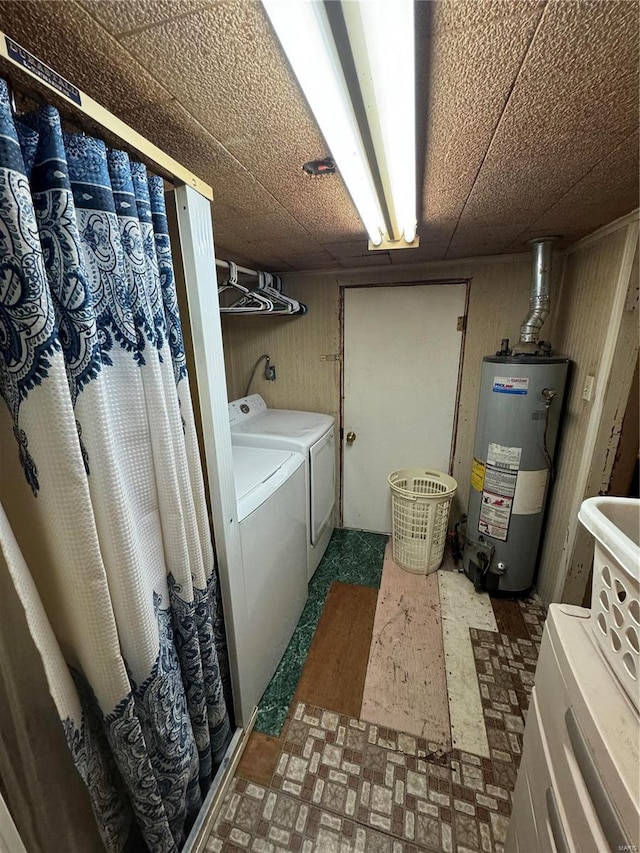 laundry area with washer and clothes dryer and water heater