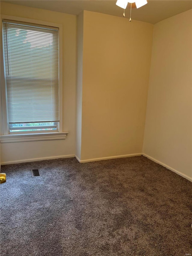 carpeted empty room featuring ceiling fan