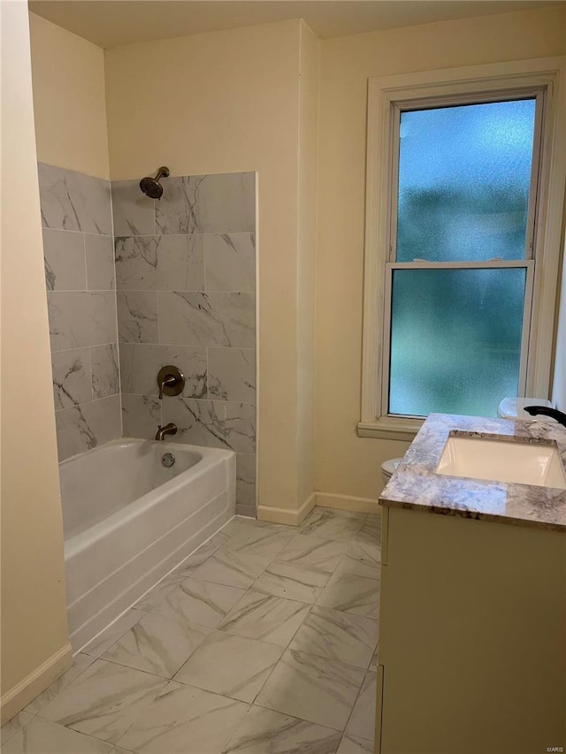 bathroom with vanity and tiled shower / bath combo