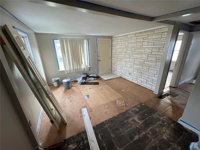 foyer entrance with a healthy amount of sunlight and beam ceiling