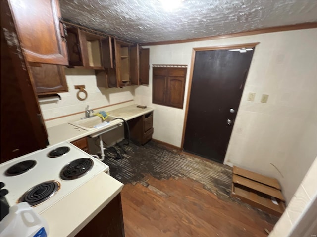 kitchen featuring dark brown cabinetry, a textured ceiling, sink, and electric range