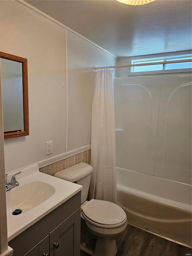 full bathroom with vanity, toilet, shower / bathtub combination with curtain, and hardwood / wood-style flooring