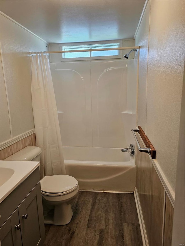 full bathroom with hardwood / wood-style floors, vanity, toilet, and shower / bath combo with shower curtain