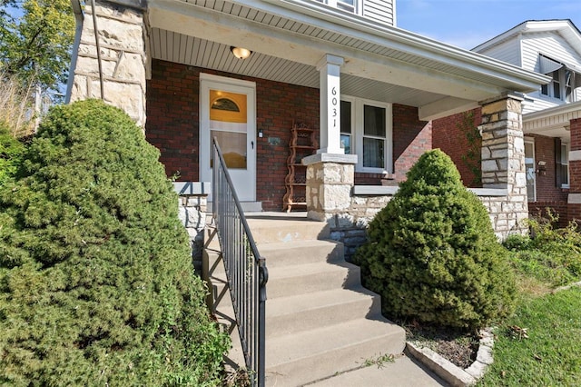 view of exterior entry with a porch