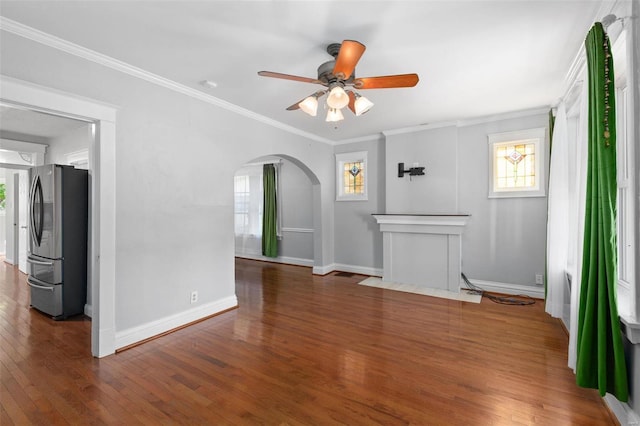 unfurnished living room featuring crown molding, ceiling fan, and dark hardwood / wood-style flooring