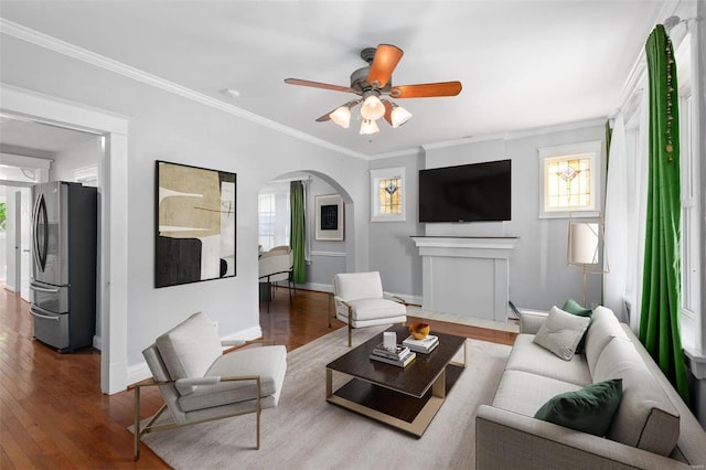 living room with ceiling fan, ornamental molding, and hardwood / wood-style floors