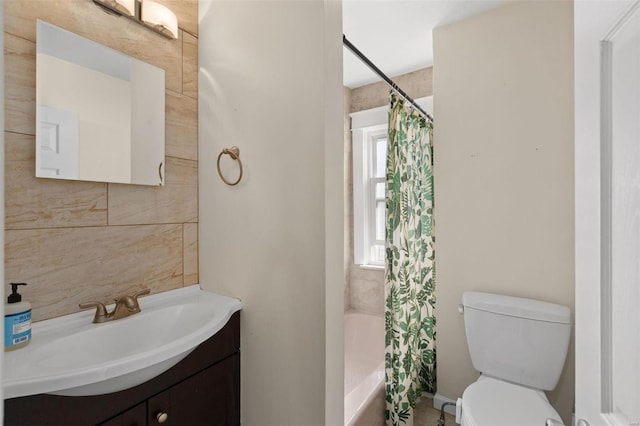 full bathroom with toilet, shower / tub combo, tile walls, and vanity