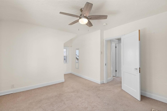 carpeted spare room with ceiling fan and a textured ceiling