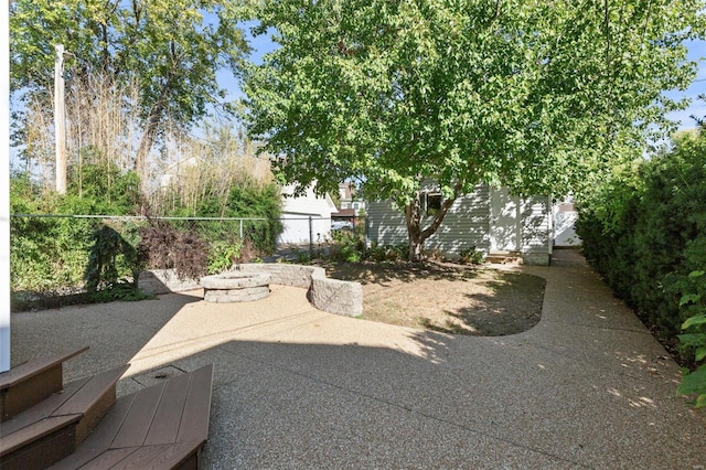 exterior space featuring a patio and an outdoor fire pit