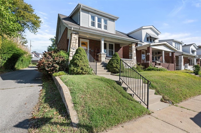 view of front of home with a porch and a front lawn