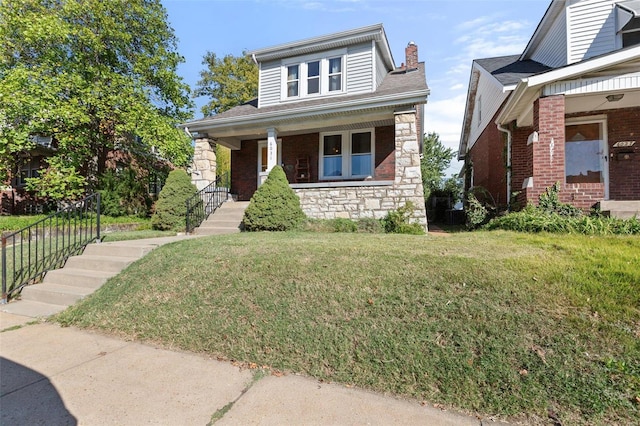 view of front of home featuring a front yard and a porch