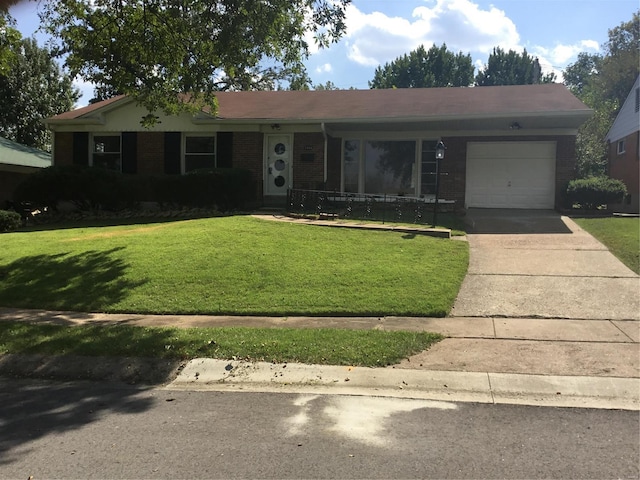 ranch-style home featuring a garage and a front lawn