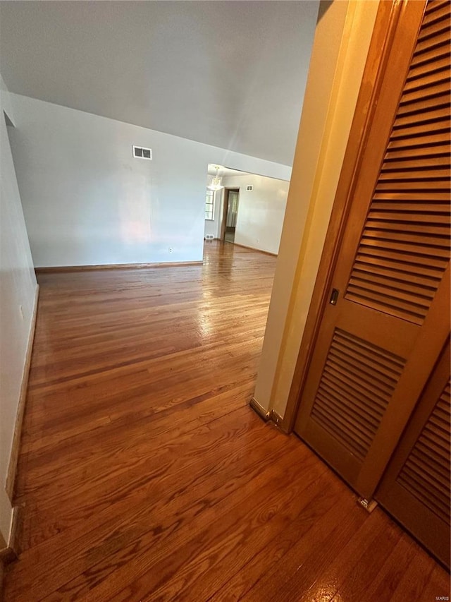 corridor with hardwood / wood-style floors